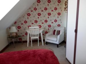 a room with a table and two chairs and a staircase at Finjaro in Sproughton