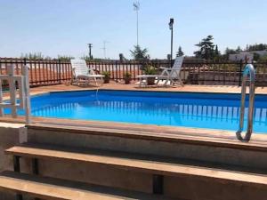 a large swimming pool with a metal hand rail at JV Country in Polignano a Mare