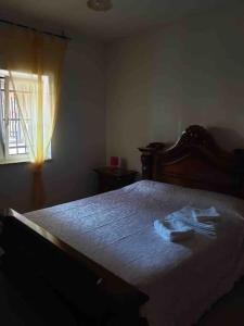 a bedroom with a bed with a robe on it at JV Country in Polignano a Mare