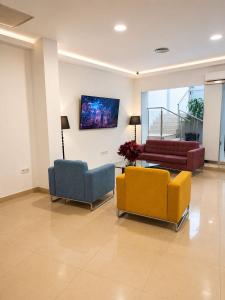 a living room with three chairs and a couch at Hotel Córdoba Centro in Córdoba +32 photos