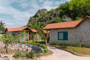 a house with a mountain in the background at Laco Green Trang An in Yên Ha