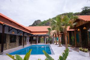 an exterior view of a house with a swimming pool at Laco Green Trang An in Yên Ha
