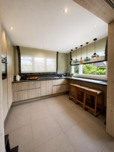 a kitchen with a bench and a sink and a window at Modern chalet next to Geneva in Divonne-les-Bains +7 photos