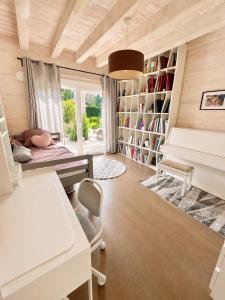 a room with a desk and a piano in it at Modern chalet next to Geneva in Divonne-les-Bains