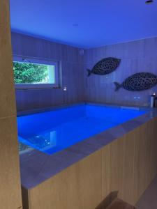 a large blue tub in a bathroom with a blue light at Modern chalet next to Geneva in Divonne-les-Bains