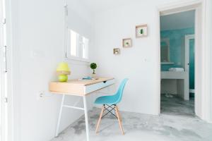 a desk and a chair in a room at Almond Deluxe Suite in Santorini