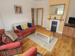 a living room with two couches and a fireplace at River House in Ballina +23 photos