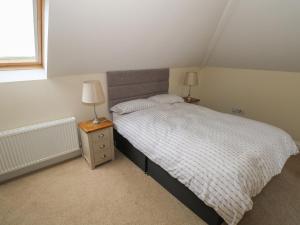 a bedroom with a bed and two lamps on a night stand at River House in Ballina