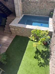 a swimming pool in a garden with green grass at Suite parentale avec un petit salon in Homps