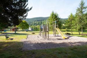 a playground with a slide in a park at Chambre d'hôtes Basinroche in Saulxures-sur-Moselotte