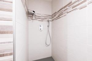 a shower in a bathroom with white tiles at Chambre d'hôtes Basinroche in Saulxures-sur-Moselotte +18 photos