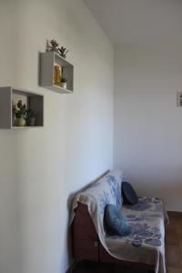 a couch sitting in a corner of a room at Baia dei Fenici in Birgi Vecchi