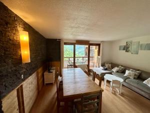 a living room with a table and a couch at La marmotte namuroise in Saint-Jean-d'Aulps