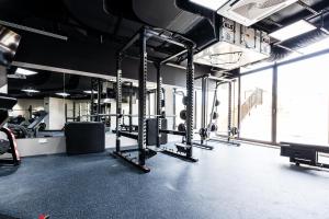 a gym with rows of squat racks and equipment at Xemxija Bay Hotel in St. Paul's Bay