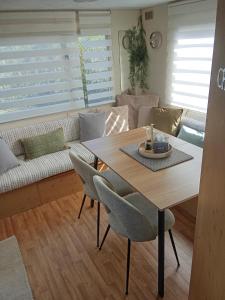 a living room with a table and a couch at Le Bruant des Roseaux in Villegusien Le Lac