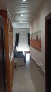 a hallway with a couch and a table in a room at SERVILUX 4 in Torremolinos