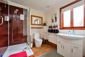 a bathroom with a shower and a sink and a toilet at Finest Retreats - The Grove Annexe in Craven Arms +19 photos