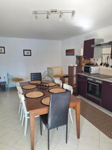 a kitchen with a table and chairs in a room at Apartman Krivičić in Cres
