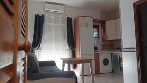 a kitchen with a table and a chair and a microwave at SERVILUX 4 in Torremolinos