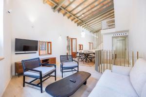 a living room with a couch and chairs and a table at Casa del Call in Palma de Mallorca