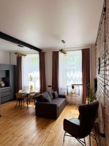 a living room with a couch and a table at Urban Loft Studio 33 in Daugavpils