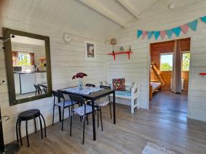 a dining room with a table and chairs at Stuga 21 i Dalskärs Camping in Bergkvara