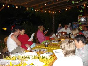a group of people are sitting around a table at Chambre d'hotes La Source Aveyron in Saint-André-de-Najac