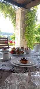 a table with plates of food on top at Siviri Traditional Stone House in Siviri