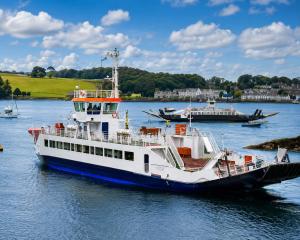 a ferry boat is docked in a body of water at The Portaferry Hotel in Portaferry