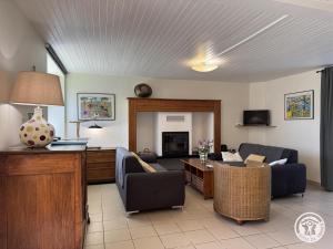 a living room with a couch and a table at Gîte brisset in Coulaures