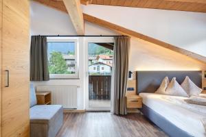 a bedroom with a bed and a large window at Residence Sonngart in Lagundo +181 photos