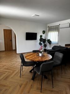a living room with a table and a couch at Dominó Apartman in Gelse