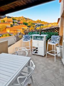 a patio with a table and chairs and a view at Casa il Bouganville - sea view Costa Paradiso in Costa Paradiso