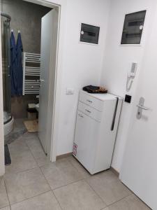 a kitchen with a white refrigerator in a room at Apartman Max in Modriča +9 photos