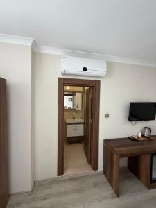 a room with a hallway with a desk and a television at LUXOR RESIDENCE in Trabzon