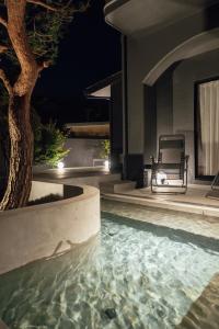 a swimming pool in front of a house at night at SOSHIJI Arashiyama in Kyoto
