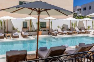 a pool with lounge chairs and an umbrella at Hoposa Panorama in Port de Pollensa