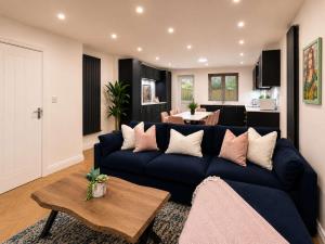 a living room with a blue couch and a table at The Blackhorse Windsor in Dorney
