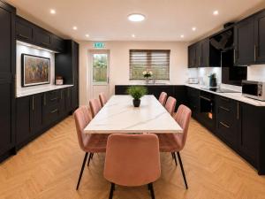 a kitchen with a table and chairs in it at The Blackhorse Windsor in Dorney
