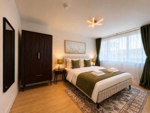 a bedroom with a large bed and a window at The Blackhorse Windsor in Dorney