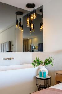 a bedroom with a mirror and a table with plants at Hotel M in Zaton