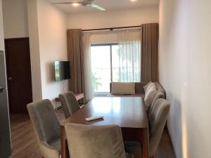 a room with a table and chairs and a couch at Arkad Golf Residence in Gonapola