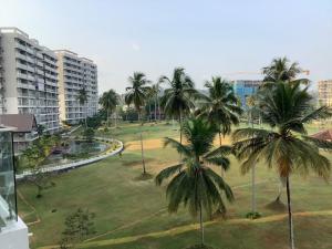a view of a park with palm trees and buildings at Arkad Golf Residence in Gonapola