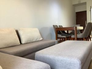 a living room with a couch and a table and chairs at Arkad Golf Residence in Gonapola