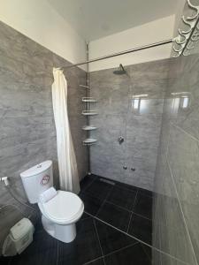 a bathroom with a toilet and a shower at Villa Noah in Ksamil +37 photos