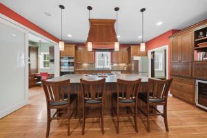 a kitchen with a large wooden table and chairs at Casa Roja in Edina