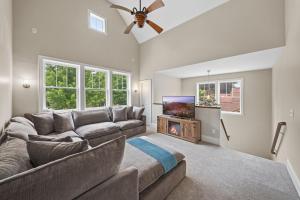 a living room with a couch and a flat screen tv at Casa Roja in Edina