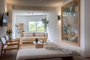 a living room with a couch and a painting on the wall at Hoposa Panorama in Port de Pollensa