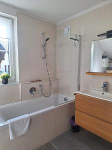 a bathroom with a shower and a tub and a sink at Appartement Urlaub Exklusiv in Lackenhof +25 photos