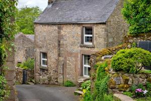 an old stone house on a street at Finest Retreats - East Bank in Matlock
